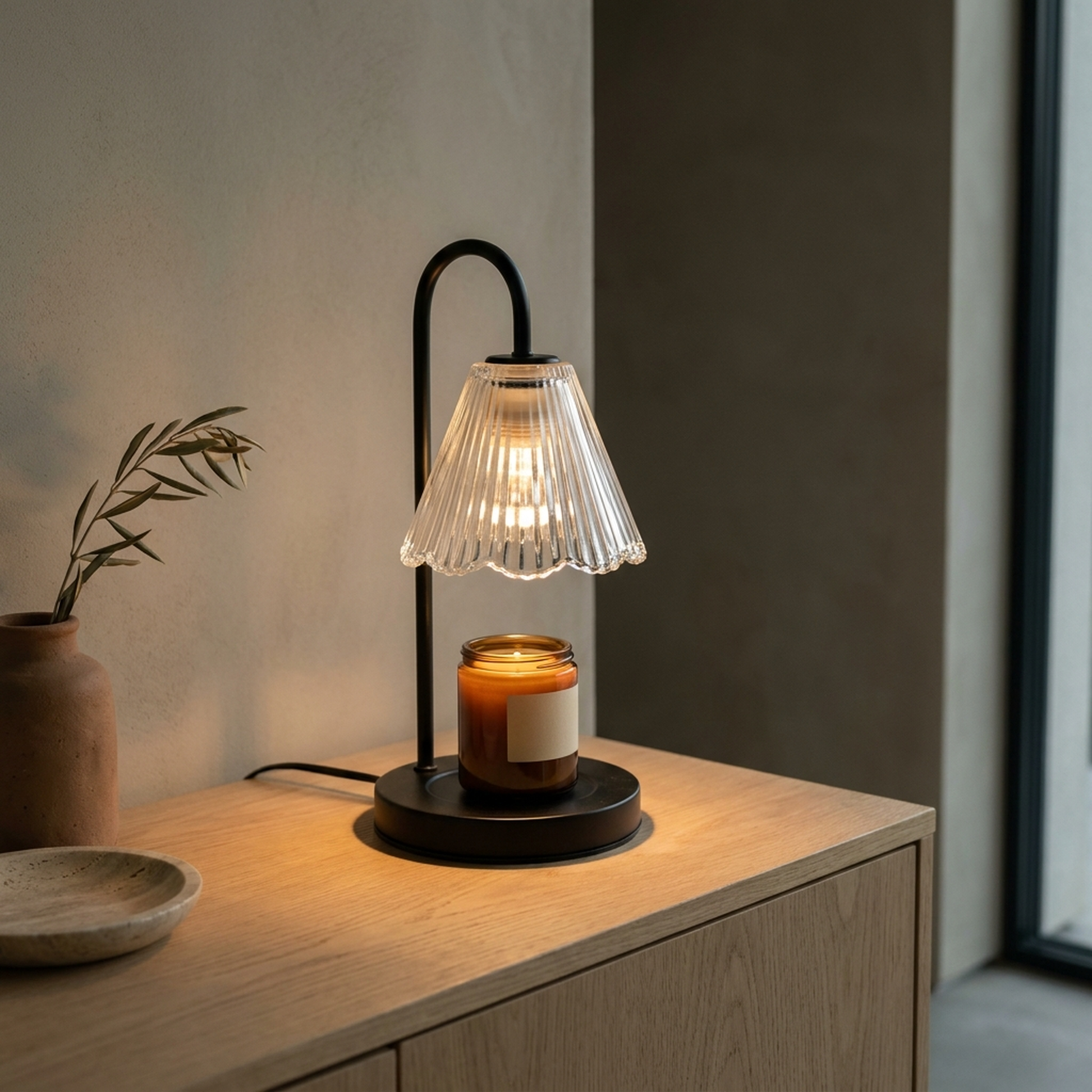 Taper™ Candle Warmer Lamp on an oak sideboard at dusk