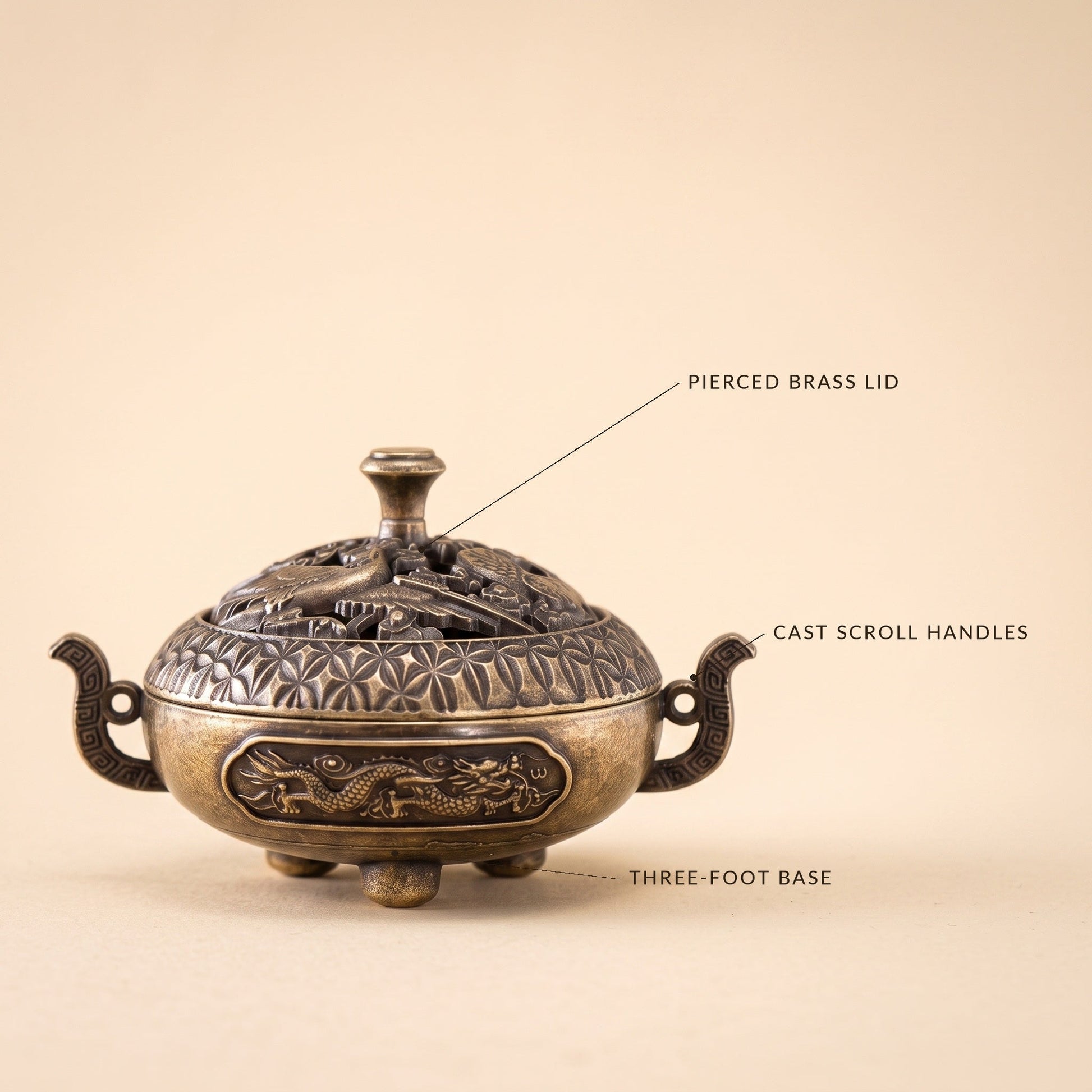 Waft™ Brass Censer detail — pierced brass lid, cast scroll handles, three-foot base
