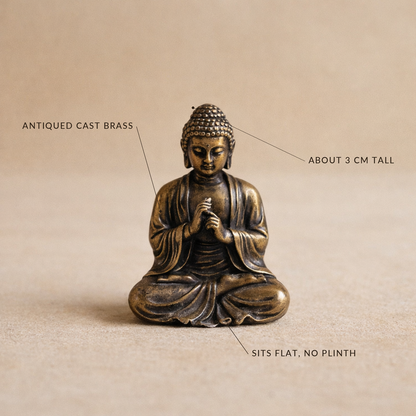 Brass Buddha labelled antiqued cast brass, about 3 cm tall, sits flat with no plinth