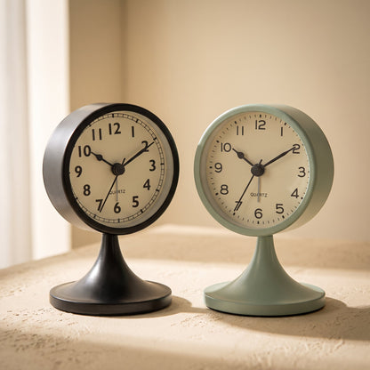 Tock™ retro alarm clocks in charcoal and sage on a warm cream surface