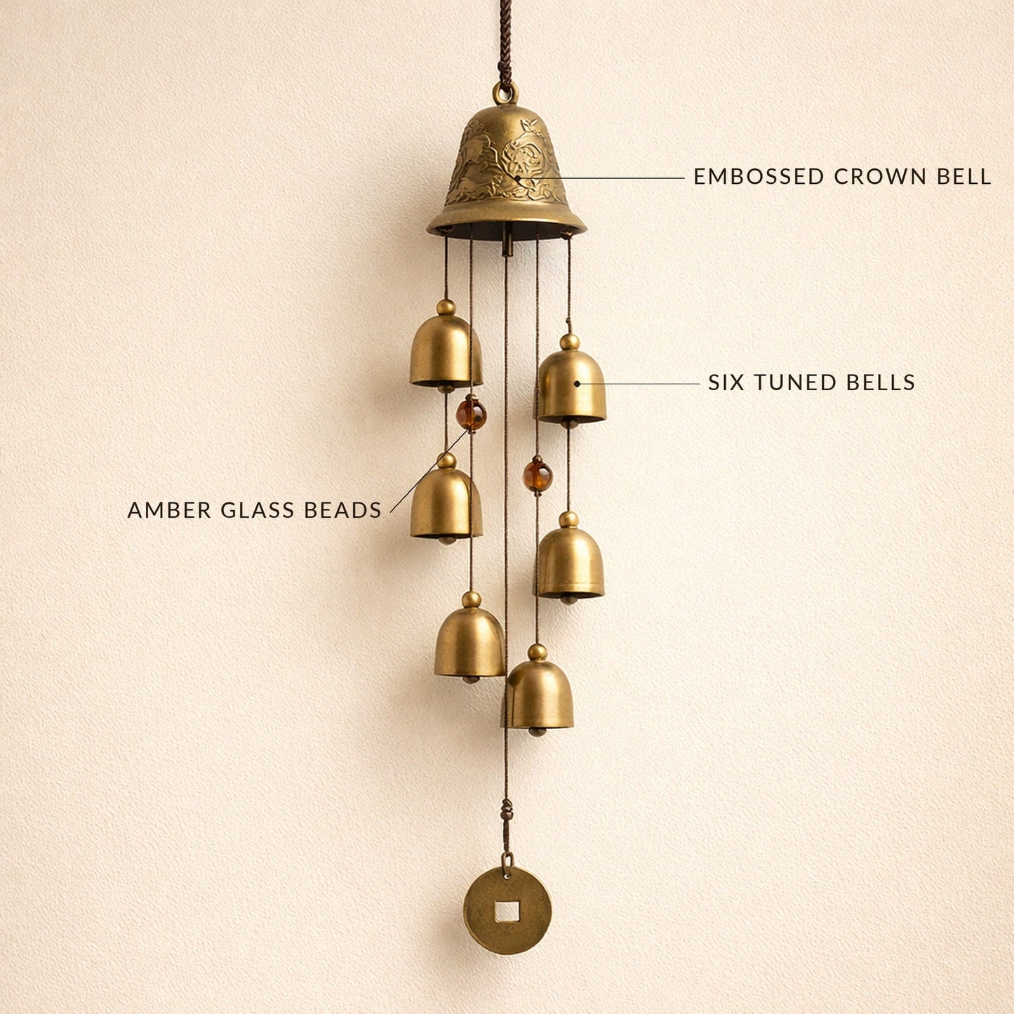 Toll™ wind chime with labelled details — embossed crown bell, six tuned bells, amber glass beads