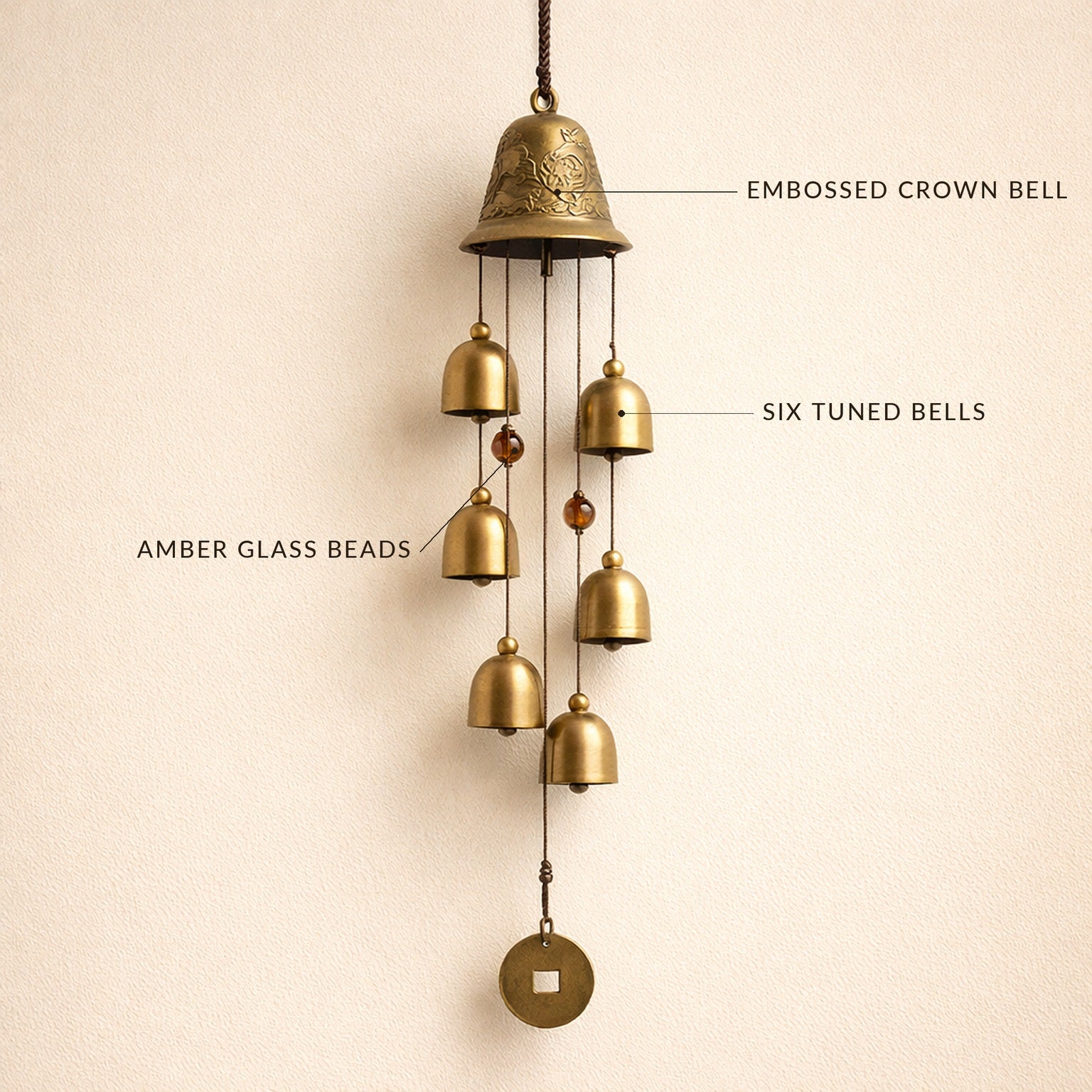Toll™ wind chime with labelled details — embossed crown bell, six tuned bells, amber glass beads