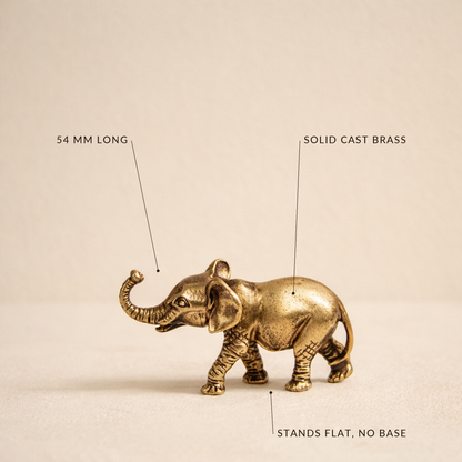Brass elephant labelled 54 mm long, solid cast brass, stands flat with no base