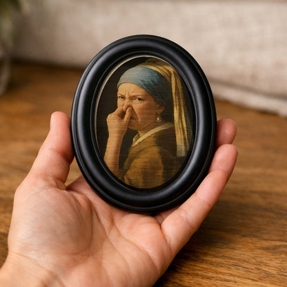 Wry Mini Portrait held in an open palm, showing how small it is